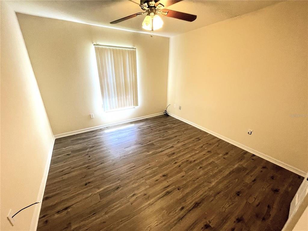 732 Bowman Terrace Port Charlotte, FL 33953 - Photo 11 of 14 a view of an empty room with wooden floor and a window