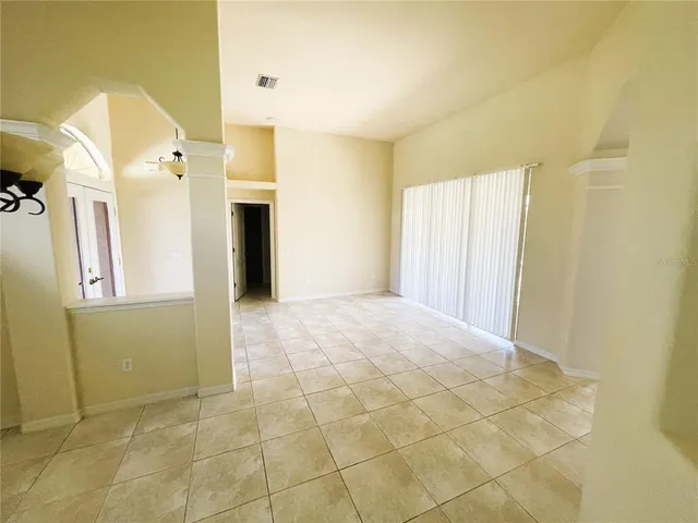 a view of a big room with wooden floor and windows