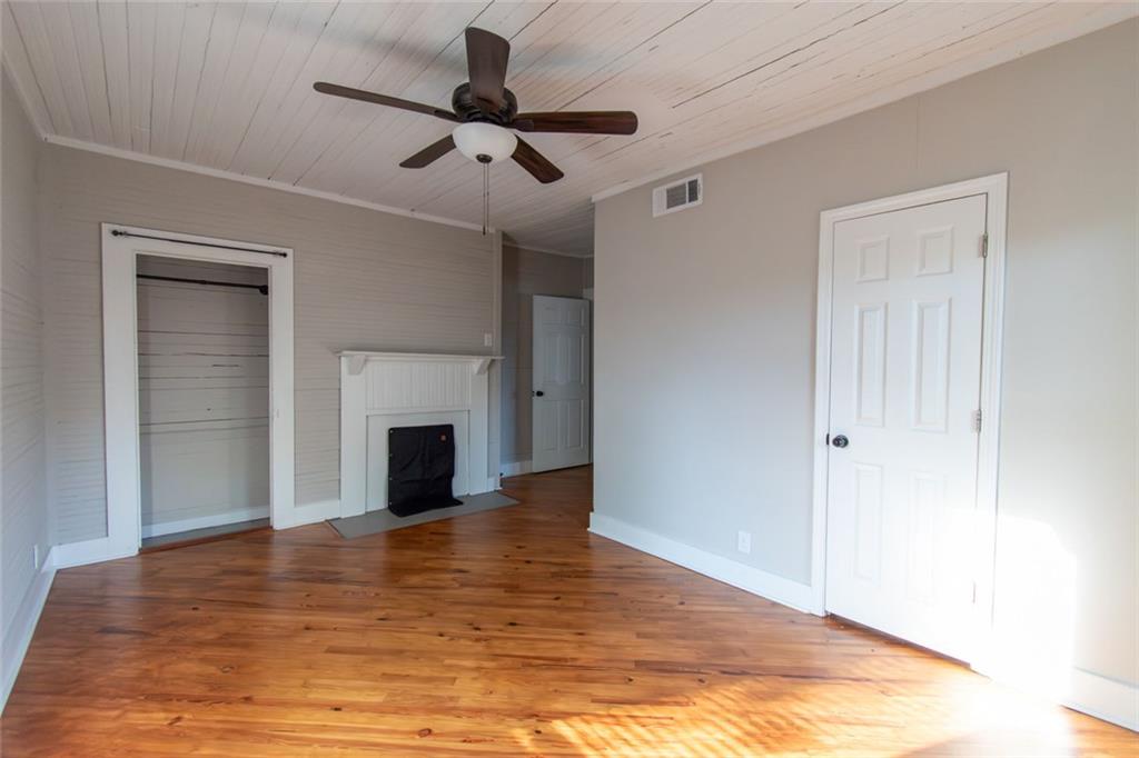 702 Radford Street Monroe, GA 30655 - Photo 33 of 49 a view of a livingroom with a fireplace a ceiling fan and hardwood floor