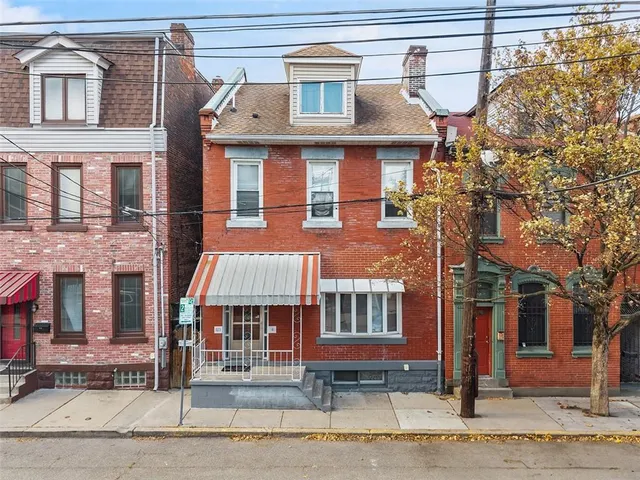 a front view of a residential apartment building with a yard