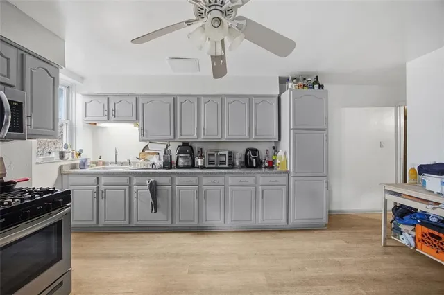 a kitchen with stainless steel appliances granite countertop a refrigerator and a stove top oven