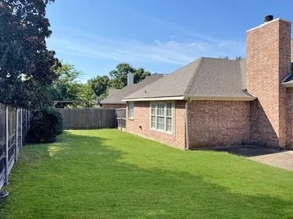 a aerial view of a house with a yard and a garage