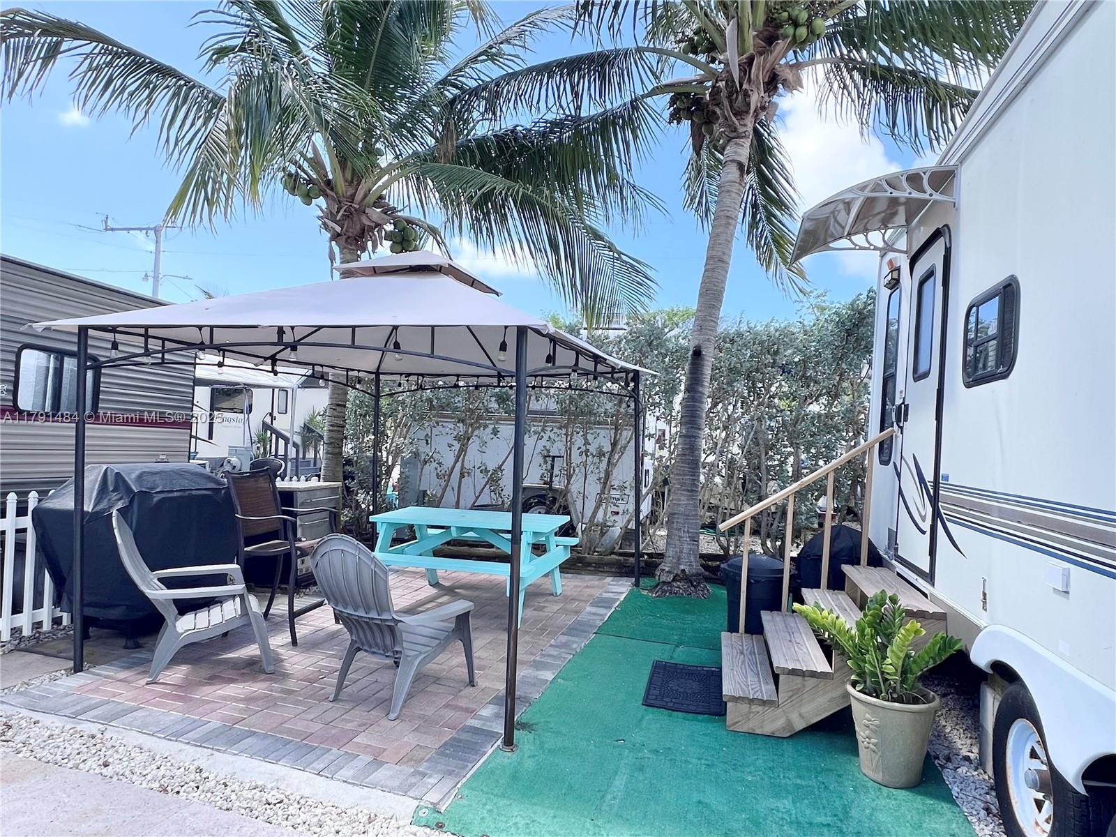 325 Calusa Street, Unit 5 Key Largo, FL 33037 - Photo 2 of 21 a view of a backyard with a patio and entertaining space