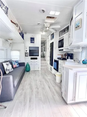 a large white kitchen with cabinets