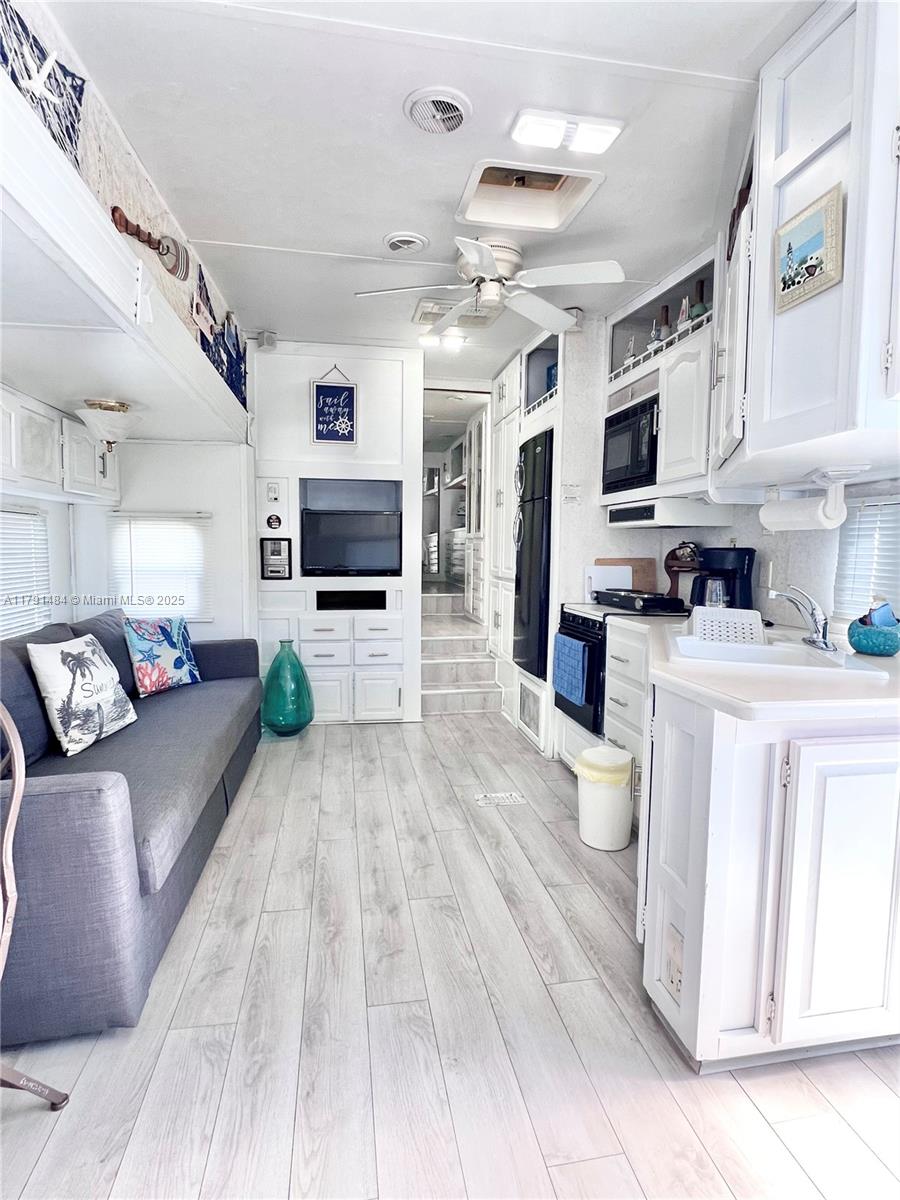 325 Calusa Street, Unit 5 Key Largo, FL 33037 - Photo 3 of 21 a large white kitchen with cabinets