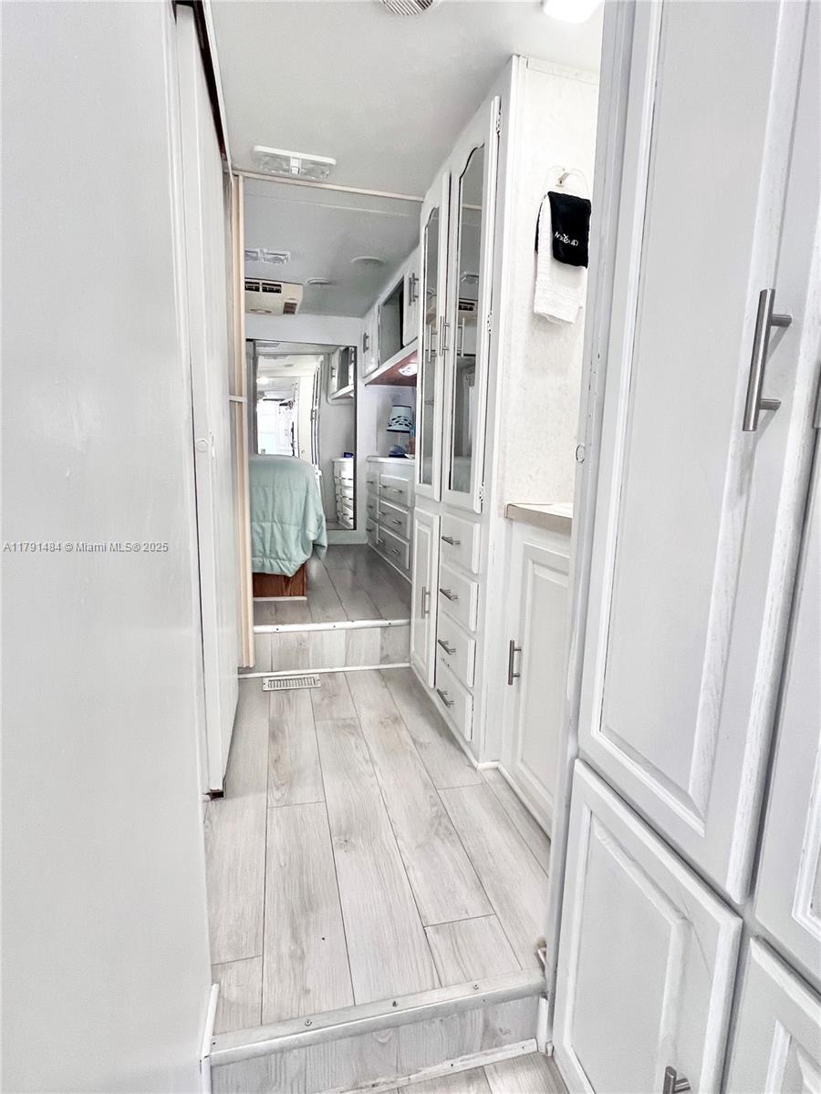 325 Calusa Street, Unit 5 Key Largo, FL 33037 - Photo 4 of 21 a view of a hallway with wooden floor and staircase