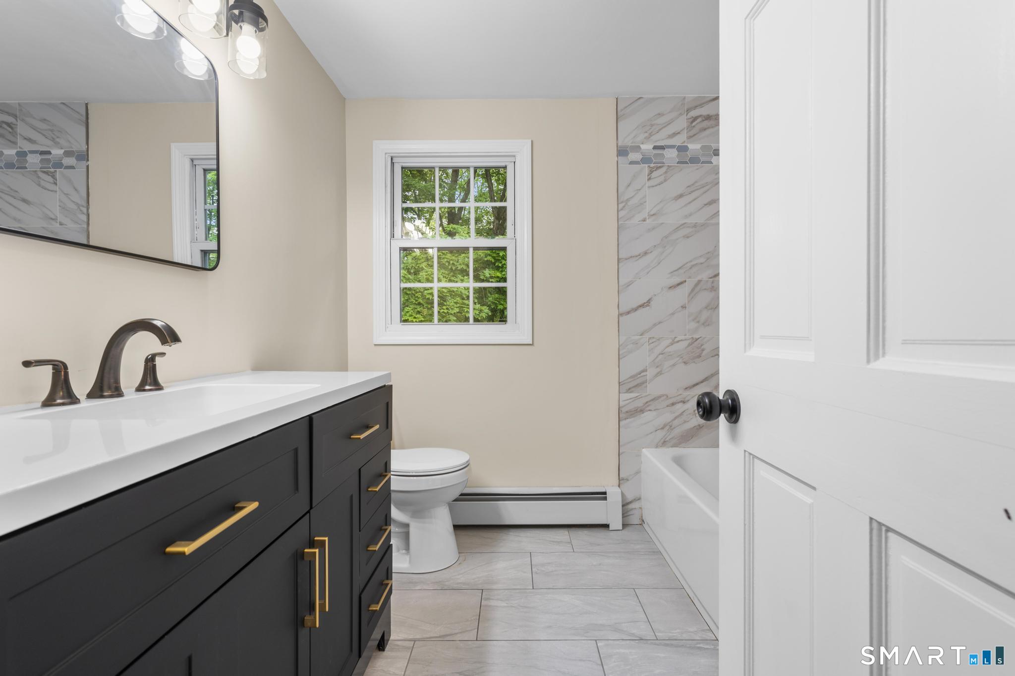 7 Sycamore Terrace Windham, CT 06280 - Photo 27 of 40 a bathroom with a sink a toilet and shower
