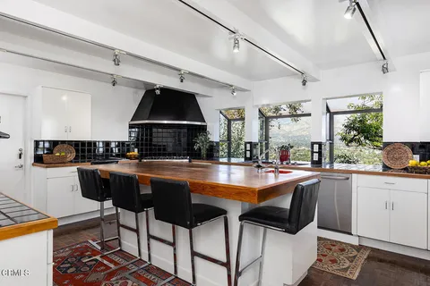 a kitchen with a table chairs stove and cabinets