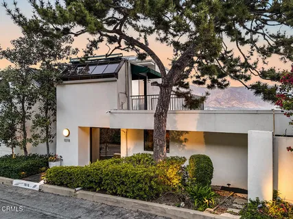 front view of a house with a tree