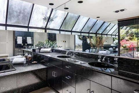 a kitchen with stainless steel appliances a sink dishwasher and cabinets with wooden floor
