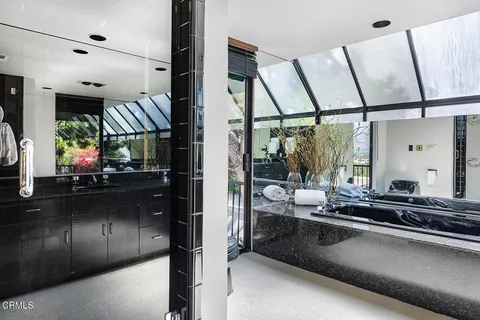 a kitchen with counter top space and windows