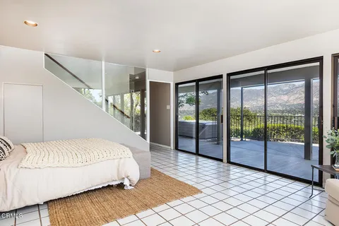 a bedroom with a bed and a large window