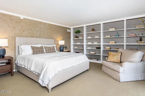 a bedroom with a bed and a couch