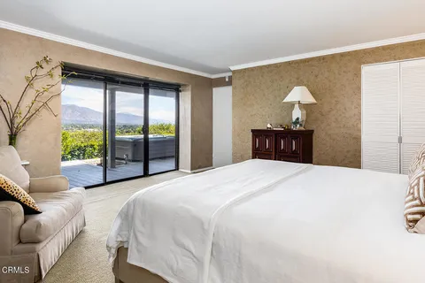 a bedroom with a large bed and a dresser
