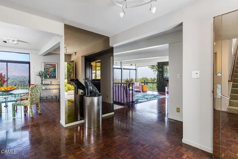 a view of a hallway with wooden floor windows and livingroom