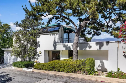 front view of a house with a tree
