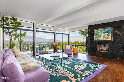 a living room with patio furniture and a floor to ceiling window