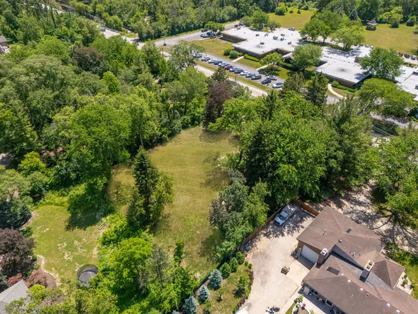 an aerial view of residential house with yard and swimming pool