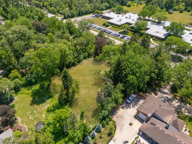 an aerial view of residential house with yard and swimming pool