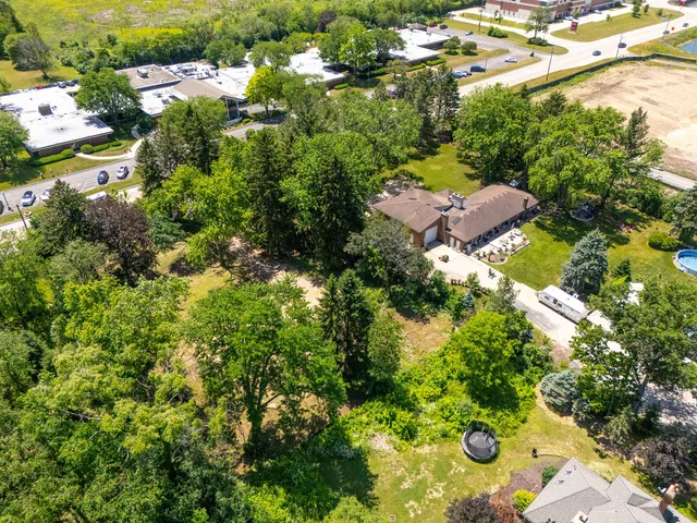 an aerial view of a residential houses with yard