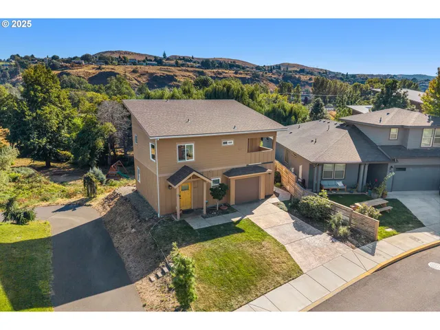a aerial view of a house with a garden and lake view