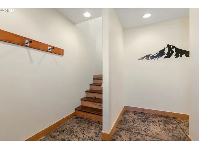 a view of a room with stairs and a chandelier