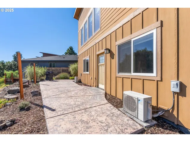 a view of a house with backyard and sitting area