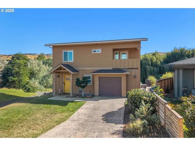 an aerial view of a house with a yard and balcony