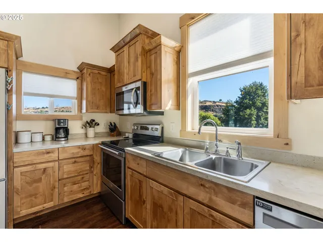 a kitchen that has a sink and a stove in it