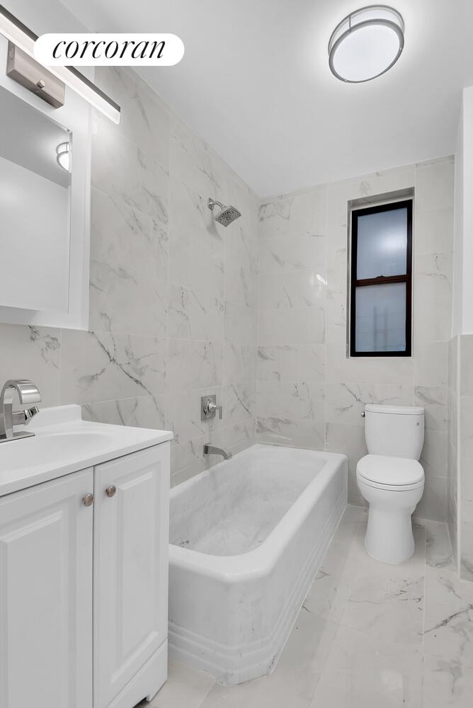 3245 Perry Avenue, Unit 1B Bronx, NY 10467 - Photo 5 of 6 a bathroom with a sink a toilet and a bathtub