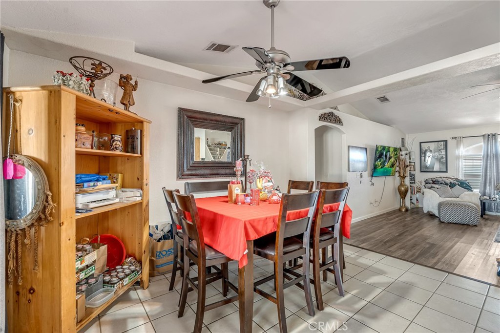 19084 Rock Springs Road Hesperia, CA 92345 - Photo 13 of 44 a view of a dining room with furniture and a chandelier