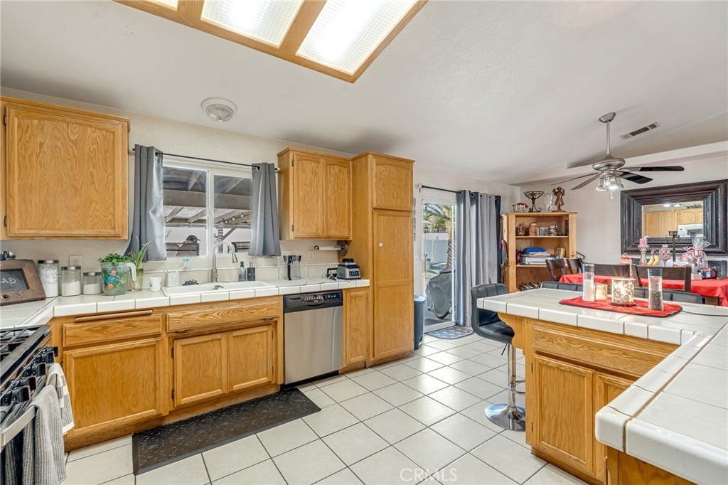 19084 Rock Springs Road Hesperia, CA 92345 - Photo 14 of 44 a kitchen that has a sink and chairs in it