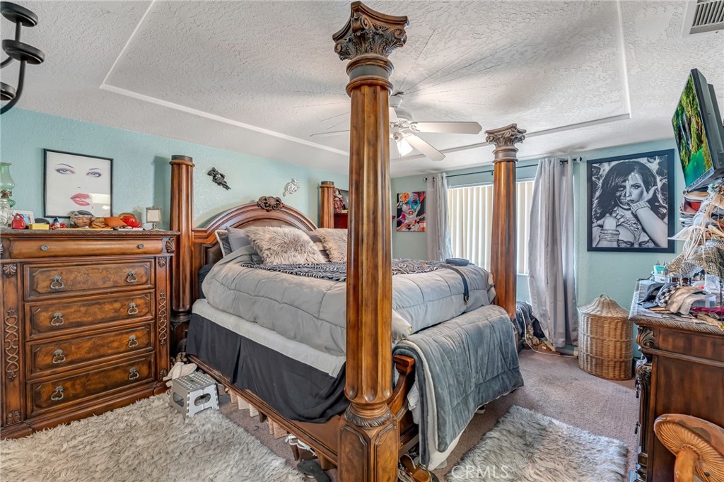19084 Rock Springs Road Hesperia, CA 92345 - Photo 20 of 44 a bedroom with a bed and wooden floor