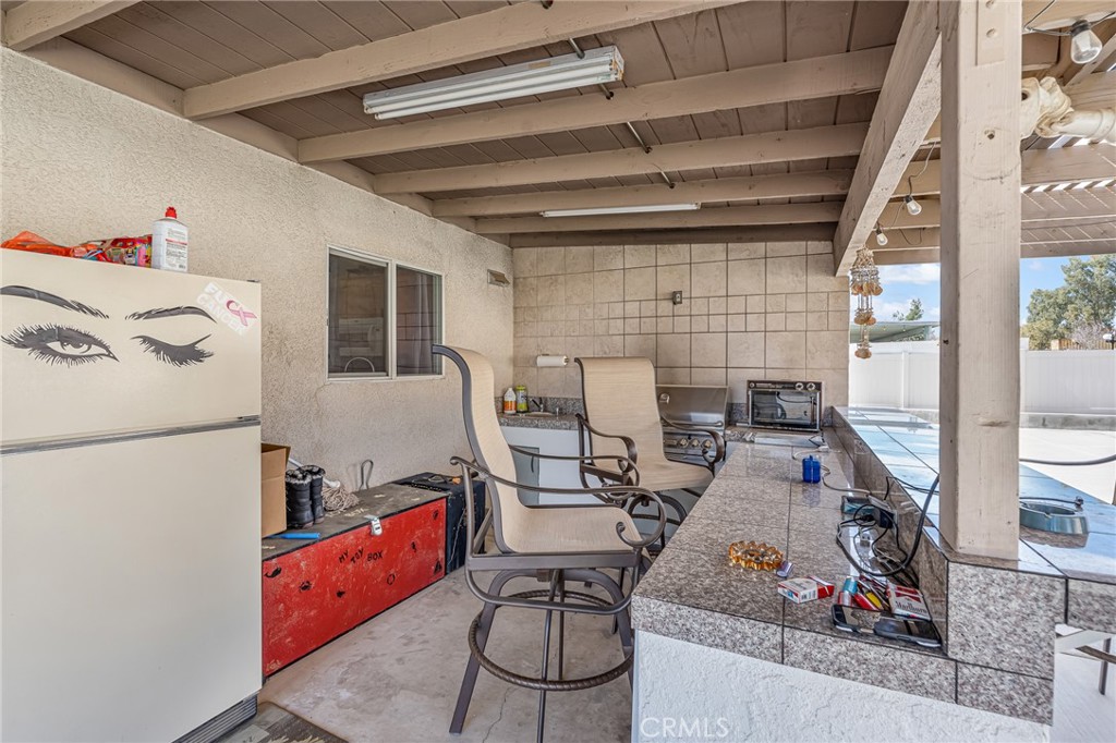 19084 Rock Springs Road Hesperia, CA 92345 - Photo 23 of 44 a view of a kitchen with fridge and workspace