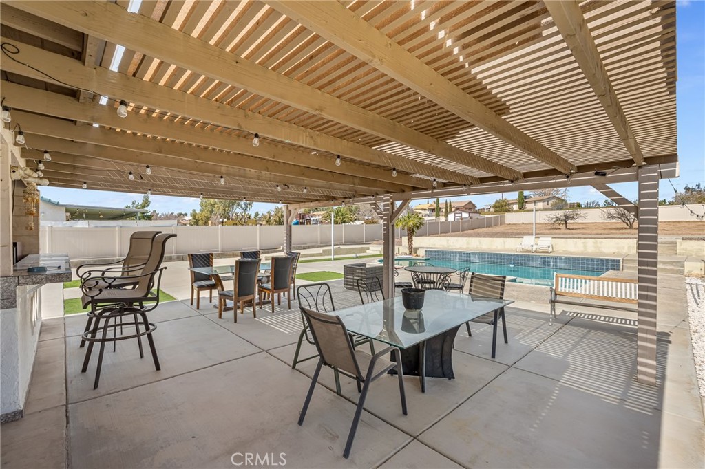19084 Rock Springs Road Hesperia, CA 92345 - Photo 25 of 44 a patio with a table and chairs