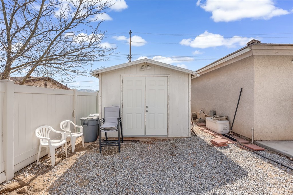 19084 Rock Springs Road Hesperia, CA 92345 - Photo 35 of 44 a backyard of a house with table and chairs
