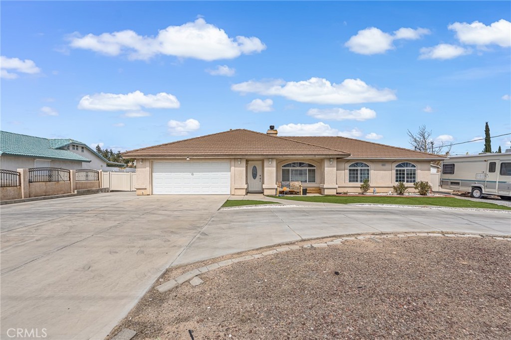 19084 Rock Springs Road Hesperia, CA 92345 - Photo 5 of 44 a front view of a house with a yard and garage
