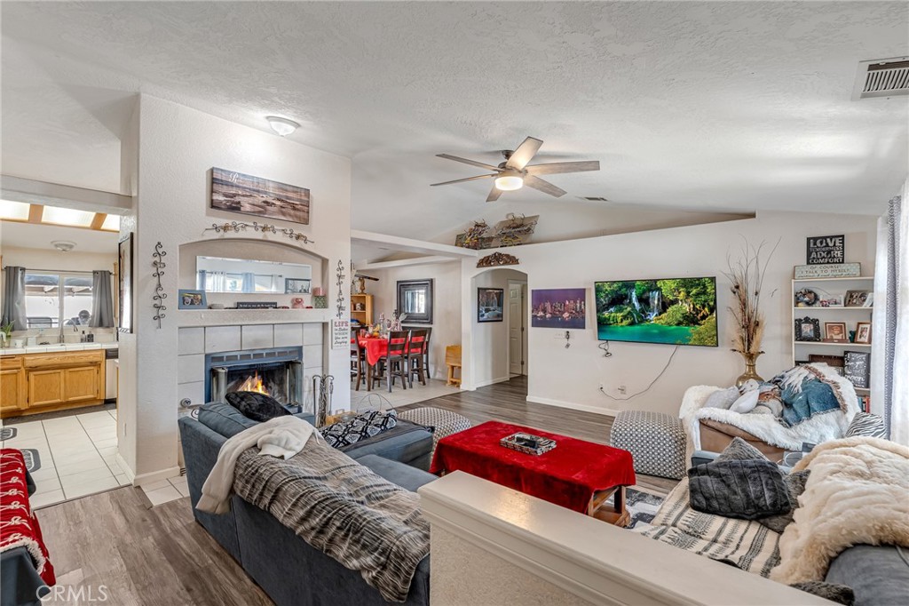 19084 Rock Springs Road Hesperia, CA 92345 - Photo 6 of 44 a living room with furniture fireplace and flat screen tv
