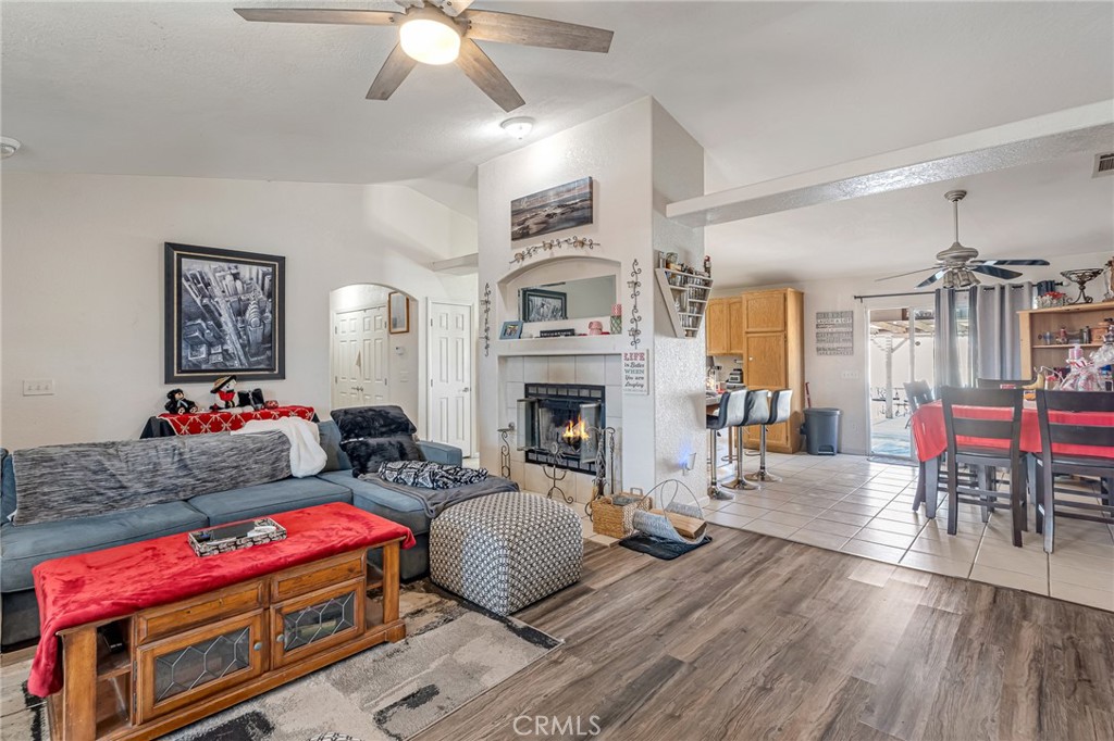 19084 Rock Springs Road Hesperia, CA 92345 - Photo 8 of 44 a living room with furniture a flat screen tv and a fireplace