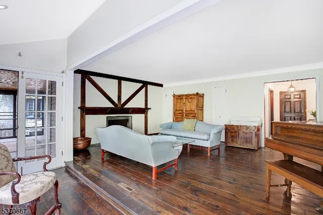 a bedroom with furniture and a wooden floor