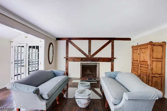 a living room with furniture a fireplace and a table
