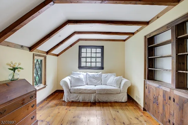 a living room with furniture and a book shelf