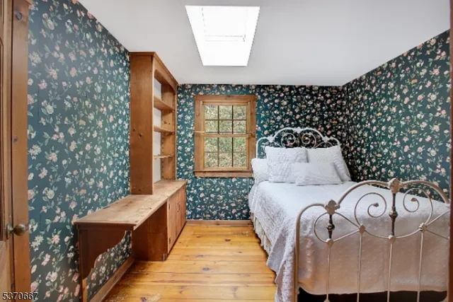 a bed room with a bed and a chair