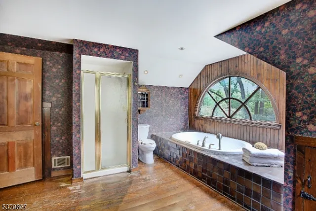 a spacious bathroom with a bathtub and a shower