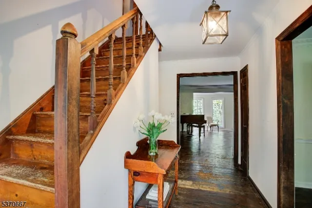 a view of a hallway with wooden floor and stairs