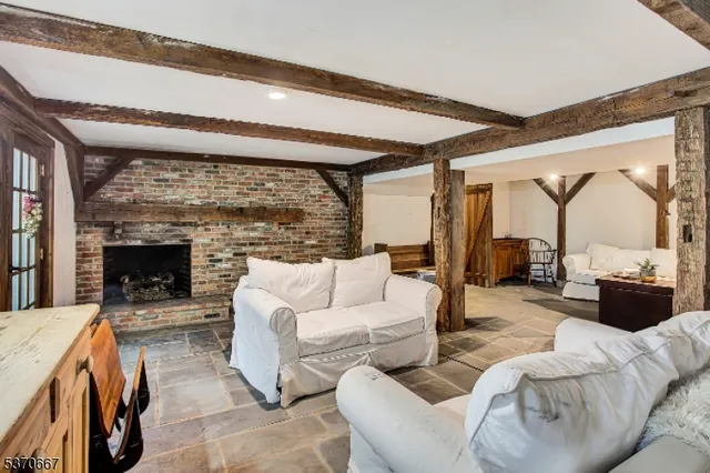 a living room with fireplace furniture and a flat screen tv