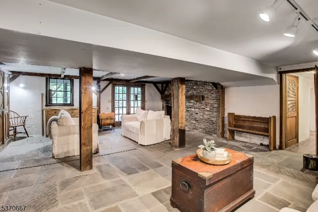 a living room with furniture a window and a fireplace