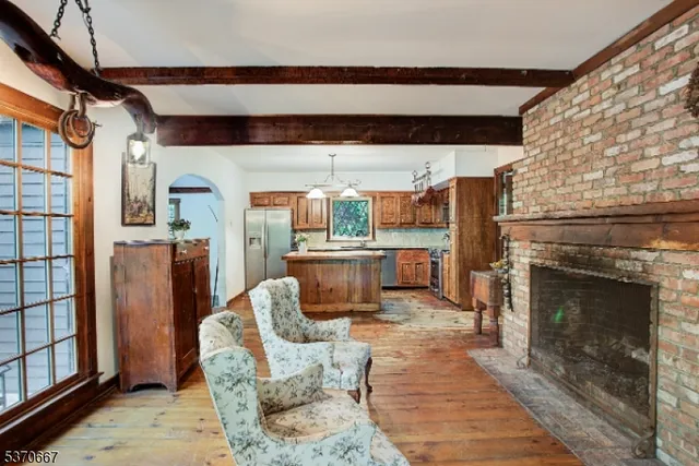 a living room with furniture a fireplace and a table