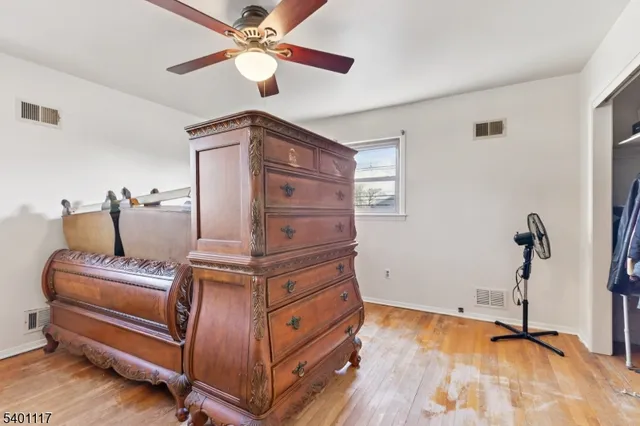 a living room with furniture and a ceiling fan