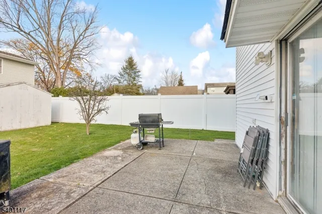 a view of backyard with seating area and trees